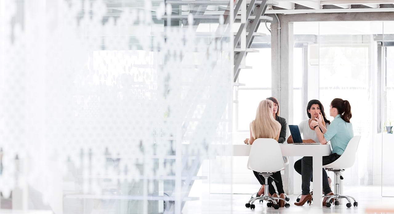 sales leader talking to her team in a conference room exercising agile sales management capabilities