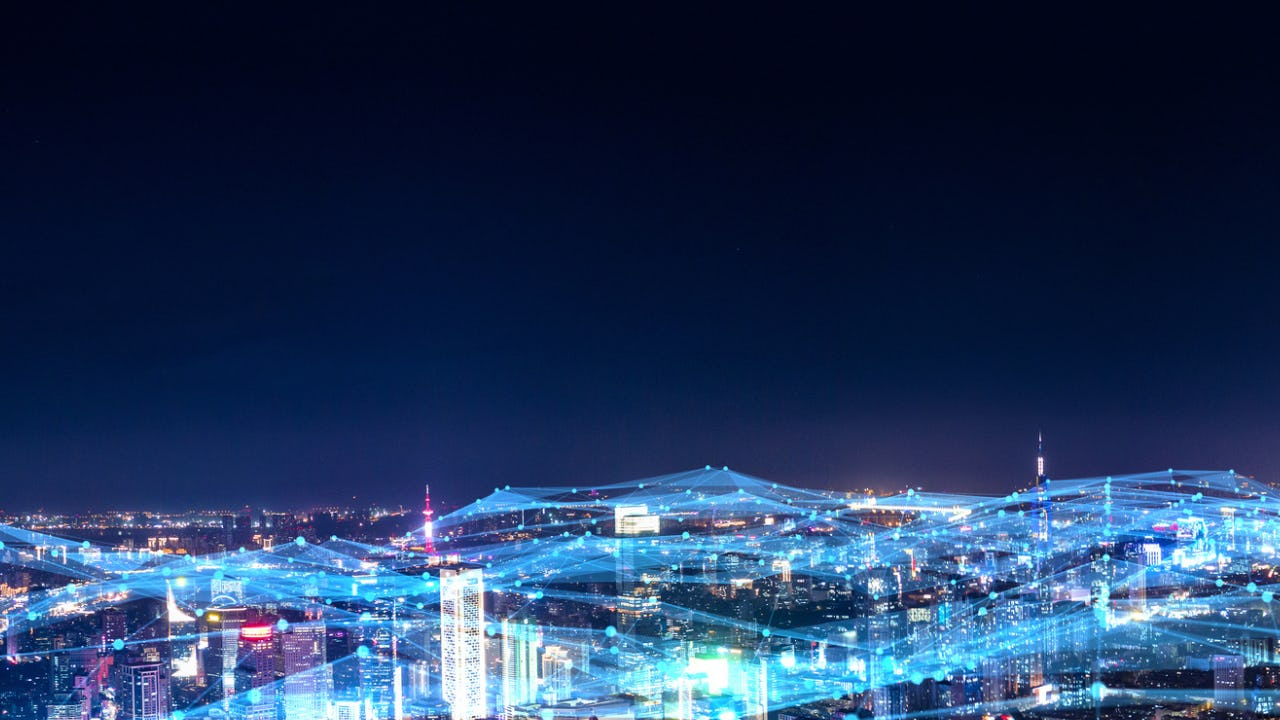 city skyline with lights connecting buildings to symbolize mitels work in telecommunications